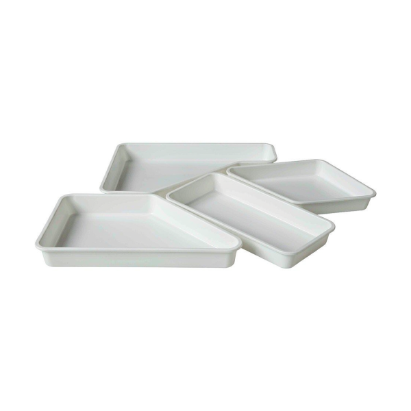 Set of four interlocking drawer organizer trays on a white background